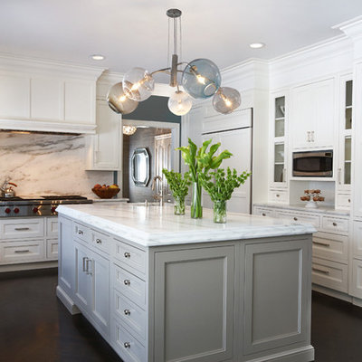 Kitchen - large transitional u-shaped dark wood floor and brown floor kitchen idea in New York with an undermount sink, recessed-panel cabinets, white cabinets, white backsplash, paneled appliances, marble countertops, marble backsplash and an island