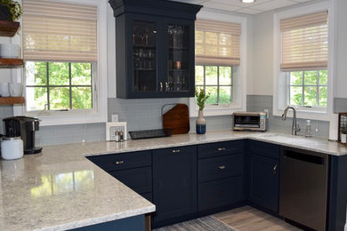 Inspiration for a small coastal u-shaped vinyl floor and gray floor open concept kitchen remodel in Providence with an undermount sink, recessed-panel cabinets, blue cabinets, quartz countertops, blue backsplash, glass tile backsplash, stainless steel appliances, an island and multicolored countertops