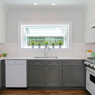 Small transitional enclosed kitchen appliance - Example of a small transitional u-shaped dark wood floor enclosed kitchen design in Chicago with an undermount sink, shaker cabinets, white cabinets, quartz countertops, white backsplash, subway tile backsplash, white appliances and no island