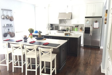 Large dark wood floor open concept kitchen photo in Chicago with an undermount sink, shaker cabinets, white cabinets, quartz countertops, multicolored backsplash, glass sheet backsplash, stainless steel appliances and two islands