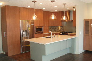 Mid-sized u-shaped medium tone wood floor eat-in kitchen photo in Calgary with an undermount sink, flat-panel cabinets, medium tone wood cabinets, quartz countertops, stainless steel appliances and an island