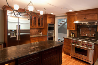 Enclosed kitchen - large traditional l-shaped light wood floor enclosed kitchen idea in Boston with shaker cabinets, light wood cabinets, marble countertops, multicolored backsplash, stone tile backsplash, stainless steel appliances and an island
