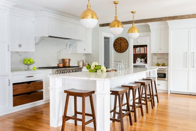 Transitional medium tone wood floor and brown floor kitchen photo in Boston with recessed-panel cabinets, white cabinets, quartz countertops, white backsplash and white countertops