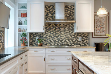 Inspiration for a large contemporary l-shaped light wood floor eat-in kitchen remodel in Wilmington with an undermount sink, beaded inset cabinets, white cabinets, granite countertops, multicolored backsplash, mosaic tile backsplash, stainless steel appliances and an island