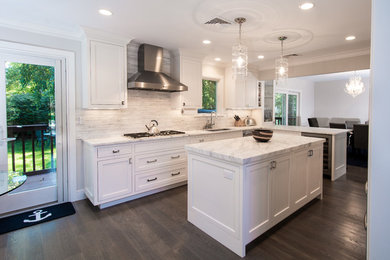 Inspiration for a mid-sized transitional galley dark wood floor eat-in kitchen remodel in New York with an undermount sink, recessed-panel cabinets, white cabinets, quartzite countertops, white backsplash, mosaic tile backsplash, stainless steel appliances and an island