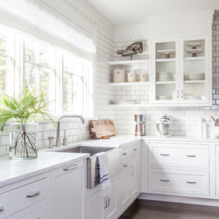 Huge transitional open concept kitchen photos - Huge transitional u-shaped dark wood floor open concept kitchen photo in New York with a farmhouse sink, shaker cabinets, white cabinets, marble countertops, white backsplash, subway tile backsplash, stainless steel appliances and an island