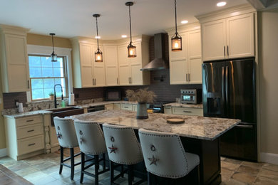 Inspiration for a mid-sized country l-shaped ceramic tile and beige floor eat-in kitchen remodel in Boston with a farmhouse sink, flat-panel cabinets, white cabinets, granite countertops, beige backsplash, ceramic backsplash, colored appliances, an island and multicolored countertops