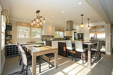 Example of a transitional l-shaped eat-in kitchen design in Vancouver with white cabinets, stainless steel appliances, an island, shaker cabinets, multicolored backsplash and mosaic tile backsplash