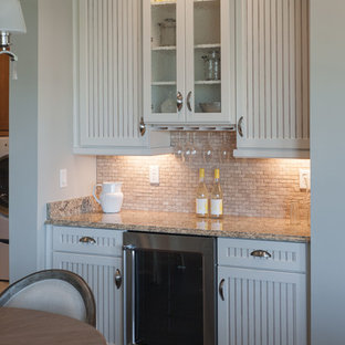 Photo of a mid-sized country single-wall eat-in kitchen in Jacksonville with a double-bowl sink, louvered cabinets, white cabinets, marble benchtops, beige splashback, stone tile splashback, stainless steel appliances, vinyl floors and with island.