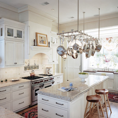 Inspiration for a large timeless u-shaped light wood floor open concept kitchen remodel in Atlanta with beaded inset cabinets, a farmhouse sink, white cabinets, granite countertops, white backsplash, stainless steel appliances and an island