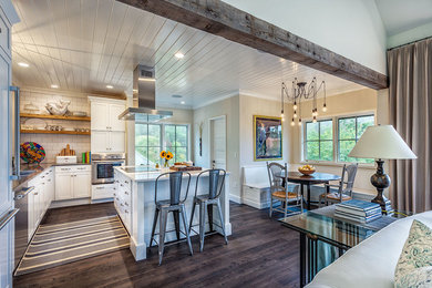 Example of an eclectic l-shaped open concept kitchen design in Other with recessed-panel cabinets, white cabinets, stainless steel appliances and an island