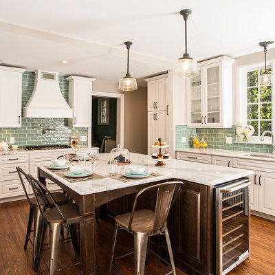 Example of a large transitional u-shaped medium tone wood floor eat-in kitchen design in Detroit with a double-bowl sink, raised-panel cabinets, white cabinets, quartz countertops, blue backsplash, ceramic backsplash, stainless steel appliances and an island