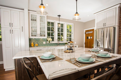 Example of a large transitional u-shaped medium tone wood floor eat-in kitchen design in Detroit with a double-bowl sink, raised-panel cabinets, white cabinets, blue backsplash, ceramic backsplash, stainless steel appliances, an island and quartz countertops