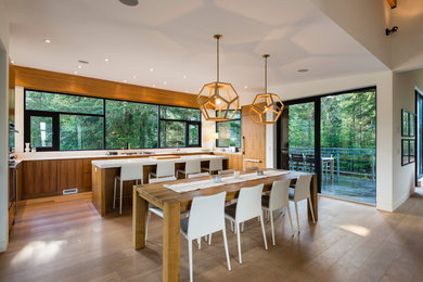 Mid-sized trendy u-shaped brown floor and medium tone wood floor eat-in kitchen photo in Vancouver with flat-panel cabinets, medium tone wood cabinets, quartz countertops, white backsplash, window backsplash, paneled appliances, an island, white countertops and an undermount sink