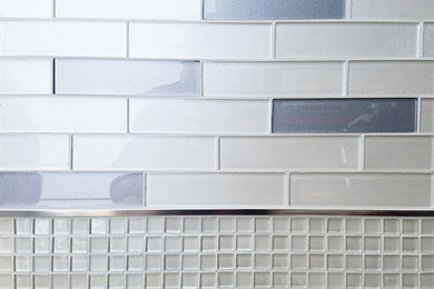 Minimalist kitchen photo in Seattle with white backsplash and glass tile backsplash