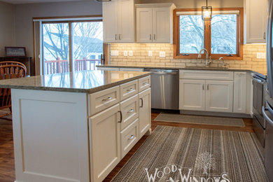 Eat-in kitchen - traditional eat-in kitchen idea in Other with shaker cabinets, white cabinets, quartzite countertops and an island