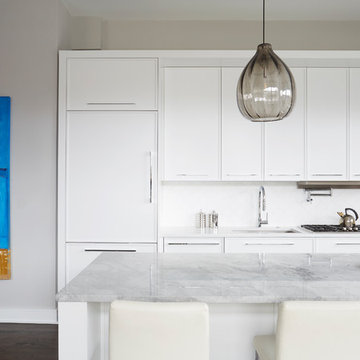 White Flat Front Cabinetry with Smokey Gray Glass Pendant Lights