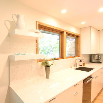 White Flat Panel Kitchen with Floating Shelves and Quartz Countertops