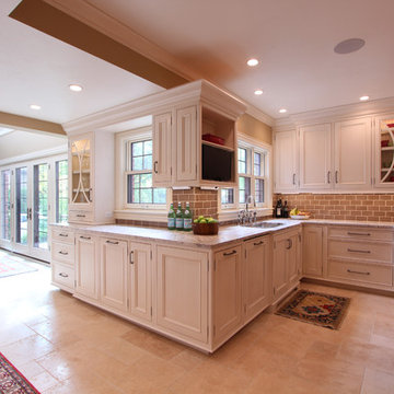 White Glazed Cabinets wrap around corner with built in TV and paneled dishwasher