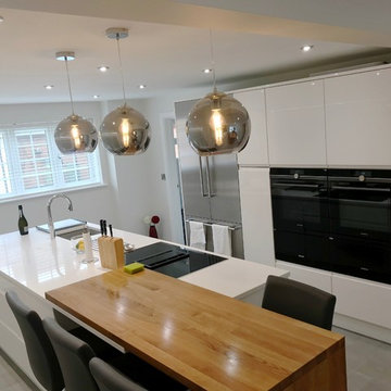 White gloss handleless kitchen with large island and exclusive Siemens appliance