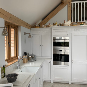 White hand painted, bespoke kitchen with larder top, island and white worktops