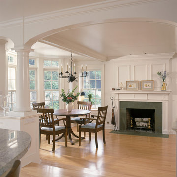 White kitchen and breakfast room with fireplace and arches