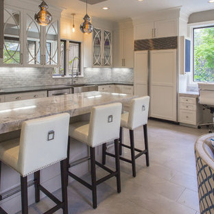This is an example of a large eclectic single-wall open plan kitchen in Houston with a farmhouse sink, glass-front cabinets, white cabinets, quartzite benchtops, white splashback, mosaic tile splashback, ceramic floors and a peninsula.