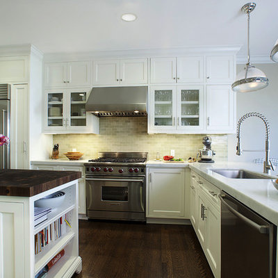 Elegant l-shaped kitchen photo in San Francisco with glass-front cabinets, marble countertops, stainless steel appliances, a single-bowl sink, white cabinets, gray backsplash and ceramic backsplash