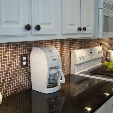White kitchen, black granite with copper backsplash