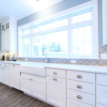 White Kitchen Cabinets with Farmhouse Sink and Gray Island