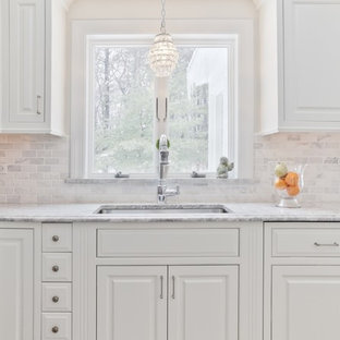 Inspiration for a timeless kitchen remodel in Boston with a single-bowl sink, raised-panel cabinets, white cabinets, white backsplash and marble backsplash