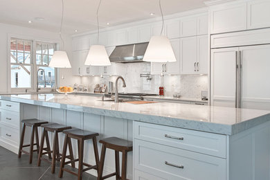 Inspiration for a large contemporary l-shaped slate floor and gray floor eat-in kitchen remodel in Tampa with an undermount sink, shaker cabinets, white cabinets, marble countertops, white backsplash, marble backsplash, stainless steel appliances and an island