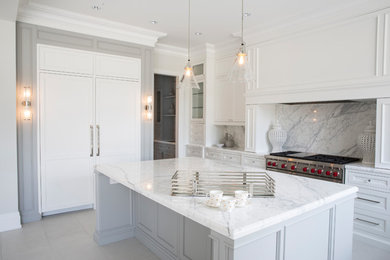 Classic u-shaped kitchen/diner in Toronto with a submerged sink, shaker cabinets, white cabinets, marble worktops, white splashback, marble splashback, stainless steel appliances and an island.