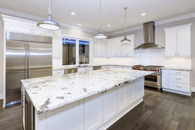 Inspiration for a large modern dark wood floor and gray floor eat-in kitchen remodel in DC Metro with an undermount sink, shaker cabinets, white cabinets, granite countertops, white backsplash, ceramic backsplash, stainless steel appliances, an island and white countertops