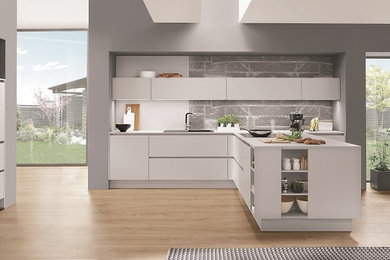 This is an example of a contemporary l-shaped open plan kitchen in West Midlands.