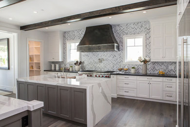 Eat-in kitchen - large transitional u-shaped medium tone wood floor and gray floor eat-in kitchen idea in Los Angeles with an undermount sink, recessed-panel cabinets, white cabinets, marble countertops, stainless steel appliances, two islands and white countertops