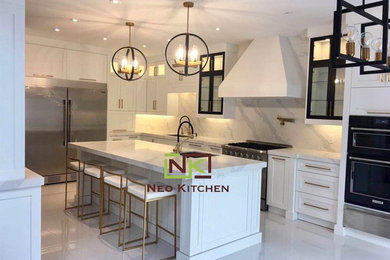 Mid-sized transitional l-shaped porcelain tile and white floor eat-in kitchen photo in Toronto with an undermount sink, shaker cabinets, white cabinets, quartz countertops, white backsplash, stone slab backsplash, stainless steel appliances, an island and white countertops