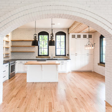 White Kitchen with Black Windows and Natural Wood Floors - Historic Charm