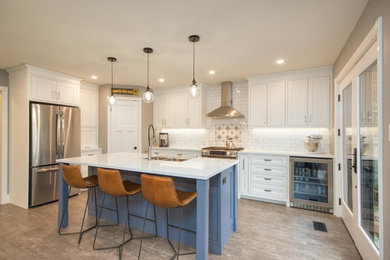 Example of a transitional kitchen design in Toronto with shaker cabinets, white cabinets, quartz countertops and white countertops
