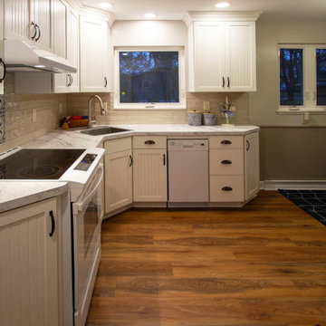 White Kitchen with Calcutta Marble Laminate Countertop and Tile Backsplash