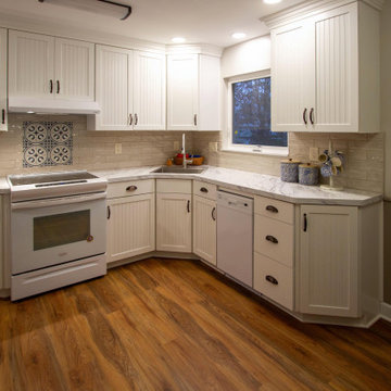 White Kitchen with Calcutta Marble Laminate Countertop and Tile Backsplash