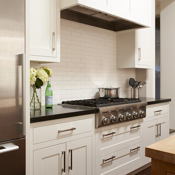 White kitchen with cooktop and hood
