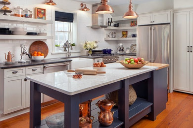 White kitchen with copper and navy  blue accents