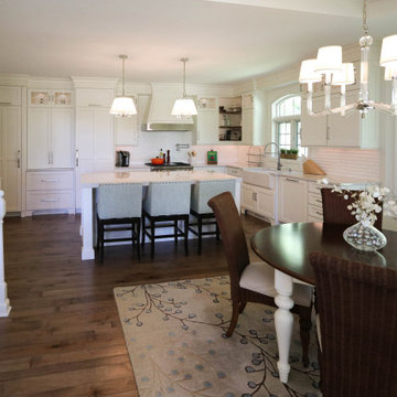 White Kitchen with Gray Quartz Countertops, Farmhouse Sink and Hardwood Floors
