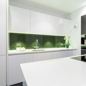 White kitchen with green splashback