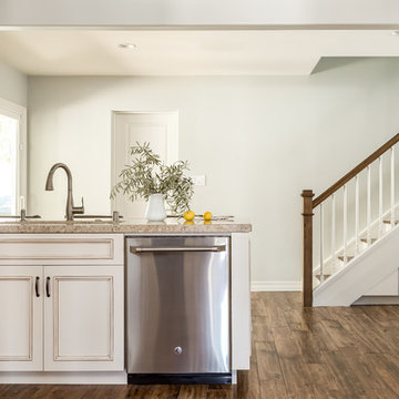 White Kitchen with Hardwood Flooring and Stainless Steel Appliances
