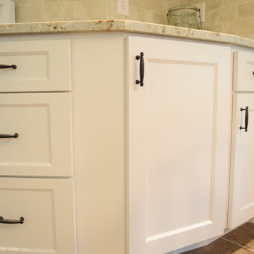 White kitchen with oil rubbed cabinet drawer pulls.