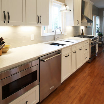 White Kitchen with Quartz Countertop, Galley Workstation and Large Subway Tile