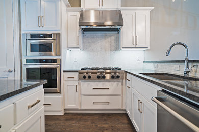 Inspiration for a large contemporary u-shaped medium tone wood floor open concept kitchen remodel in Oklahoma City with an undermount sink, shaker cabinets, white cabinets, granite countertops, white backsplash, stainless steel appliances and an island