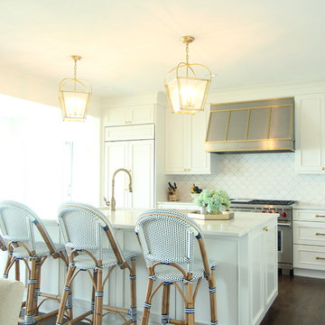 White Kitchen with Stainless and Brass Hood and Brass Hardware
